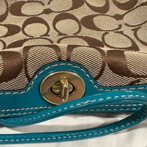 Coach signature collection turquoise wristlet with brass closure